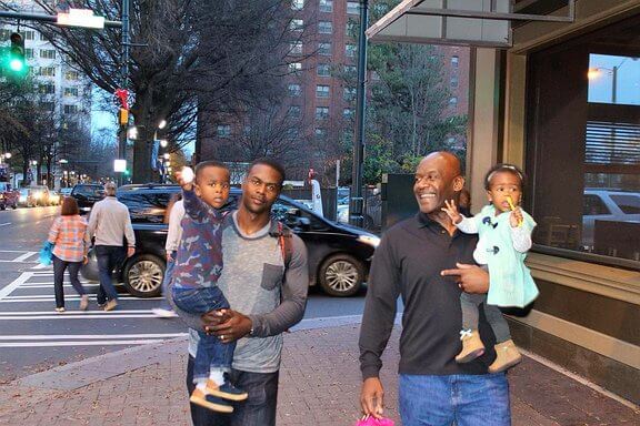 Rev. Blackmon walking with his grandchildren
